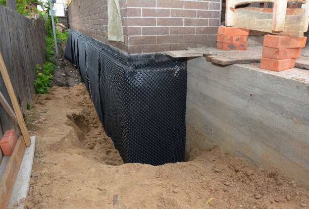 Happy homeowners after waterproofing job in Lewis